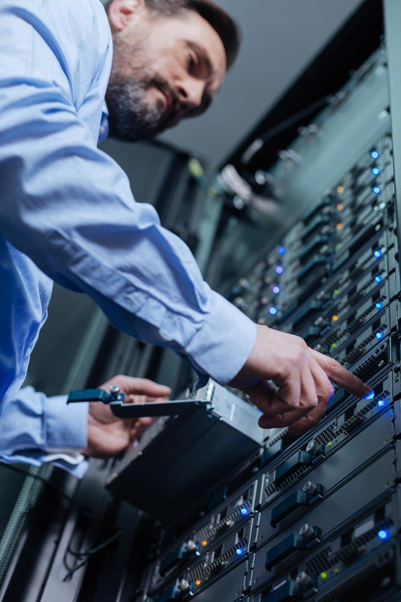 Server technician handling server equipment in a data center